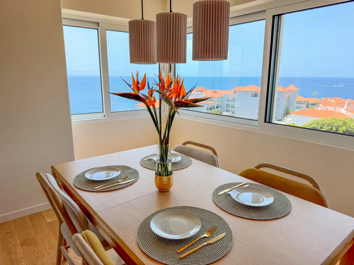 The dining table set by the ocean windows