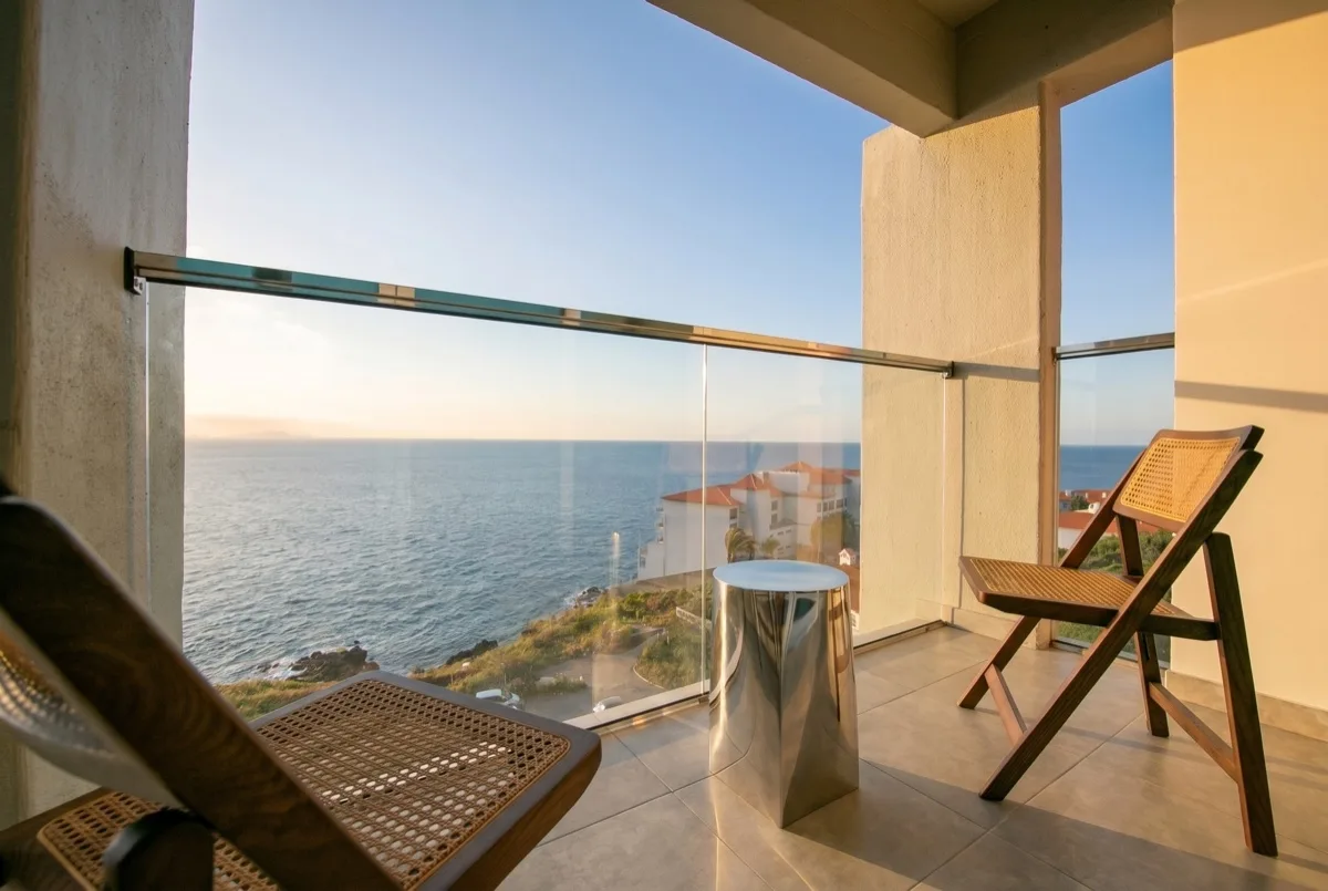 The chaise on the balcony, facing the open sea
